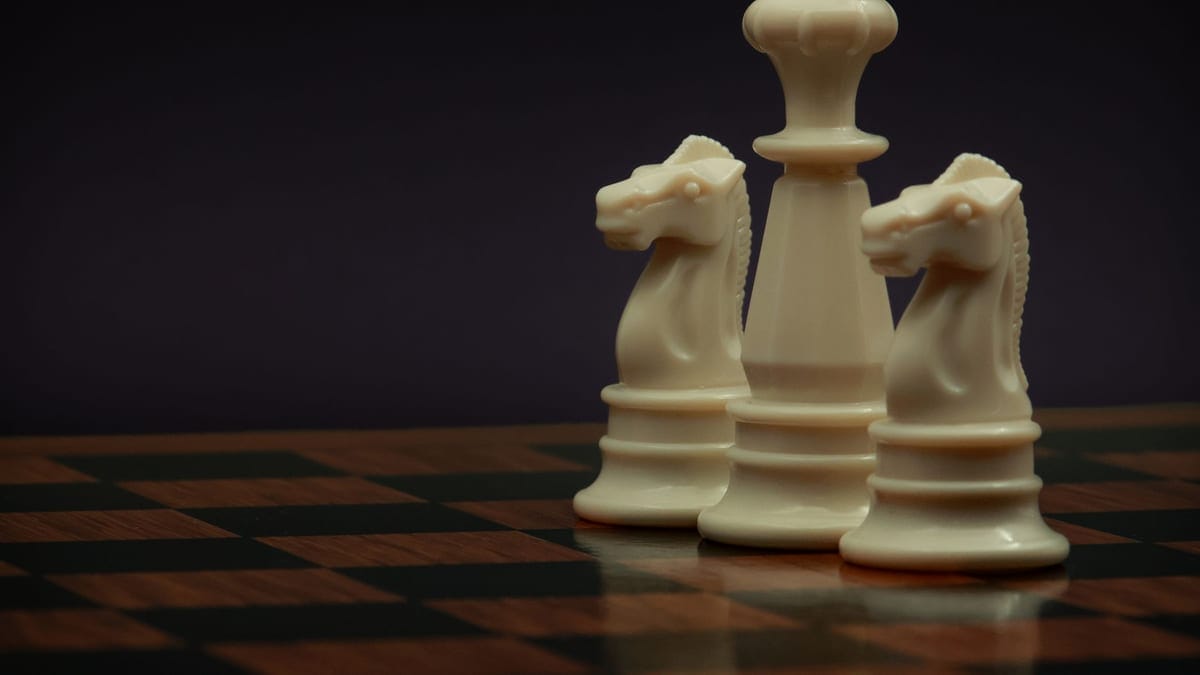 Elegant chess pieces on a board, featuring two knights and a king, symbolizing strategy and planning.