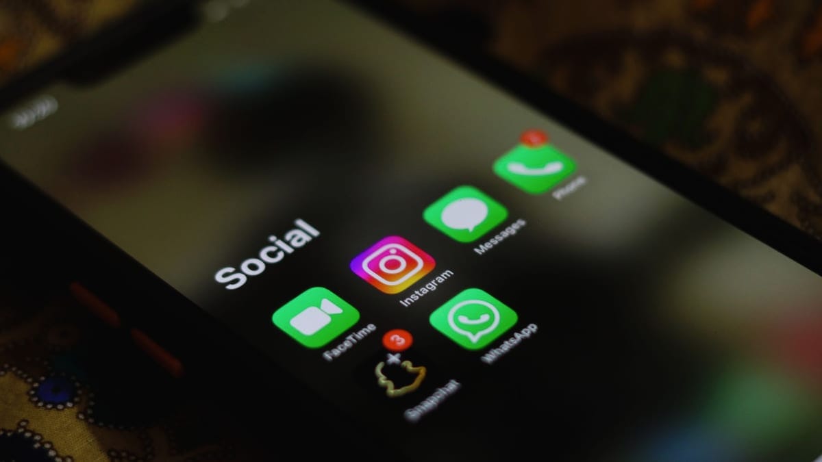 A close-up shot of smartphone displaying social media apps icons on screen.